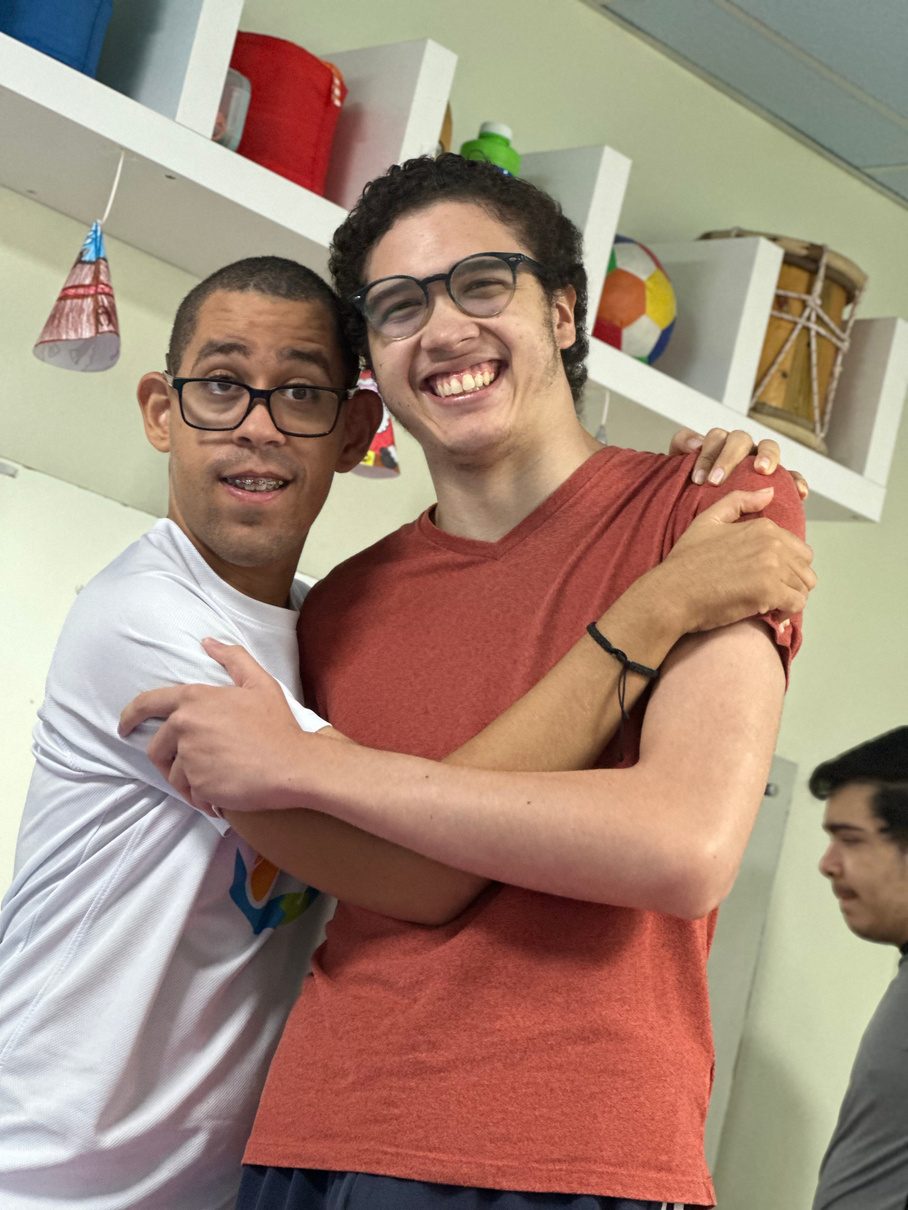 Dos jóvenes de ACEC se abrazan en el taller del centro